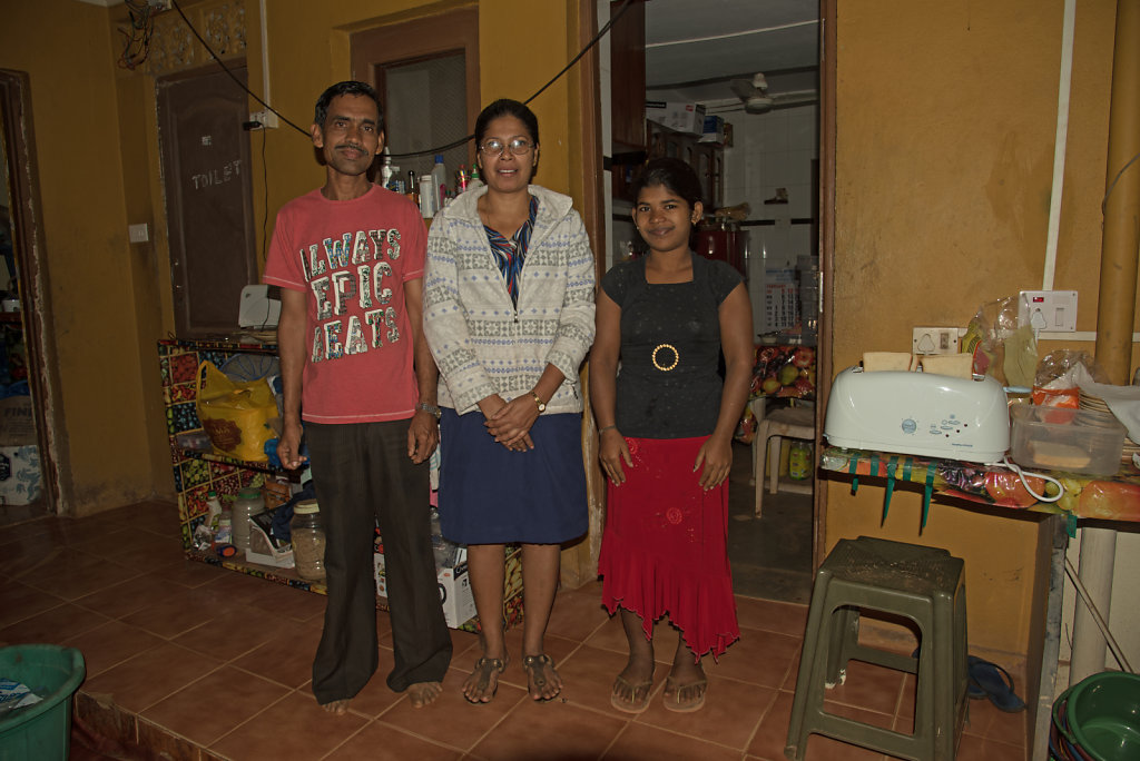 Guest House Owner (Ortulana, Centre) with Staff